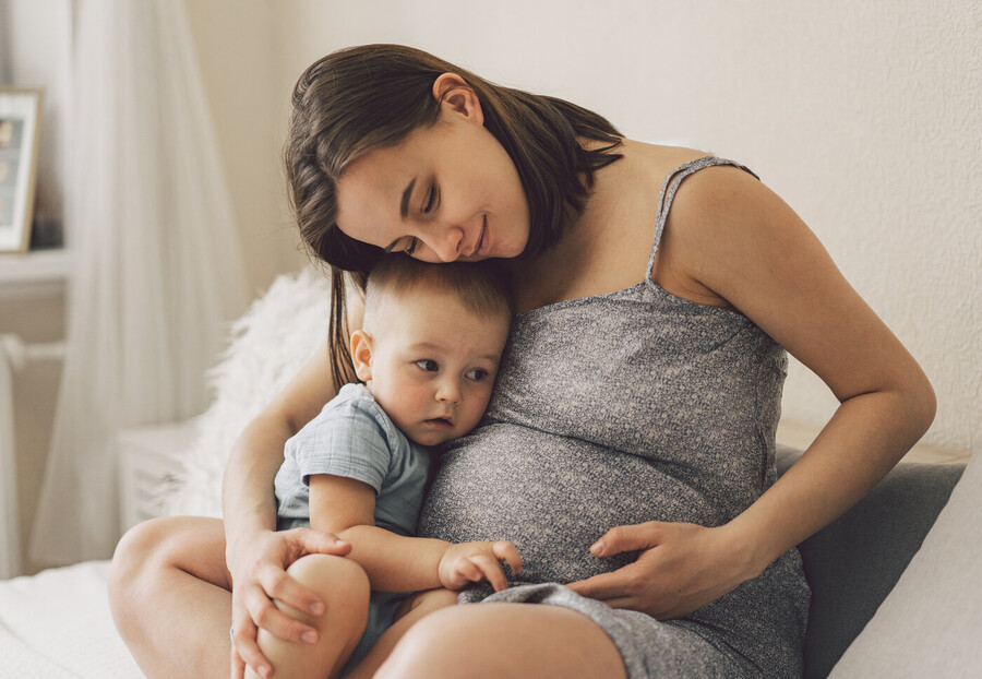 Young pregnant woman with toddler